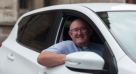 The Reverend Canon Liam Slattery and his new car